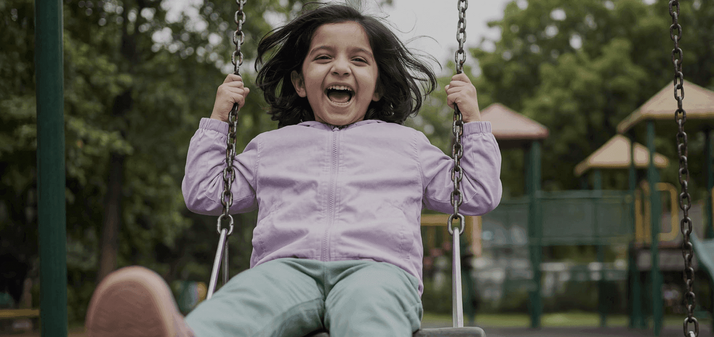 Child playing on swing